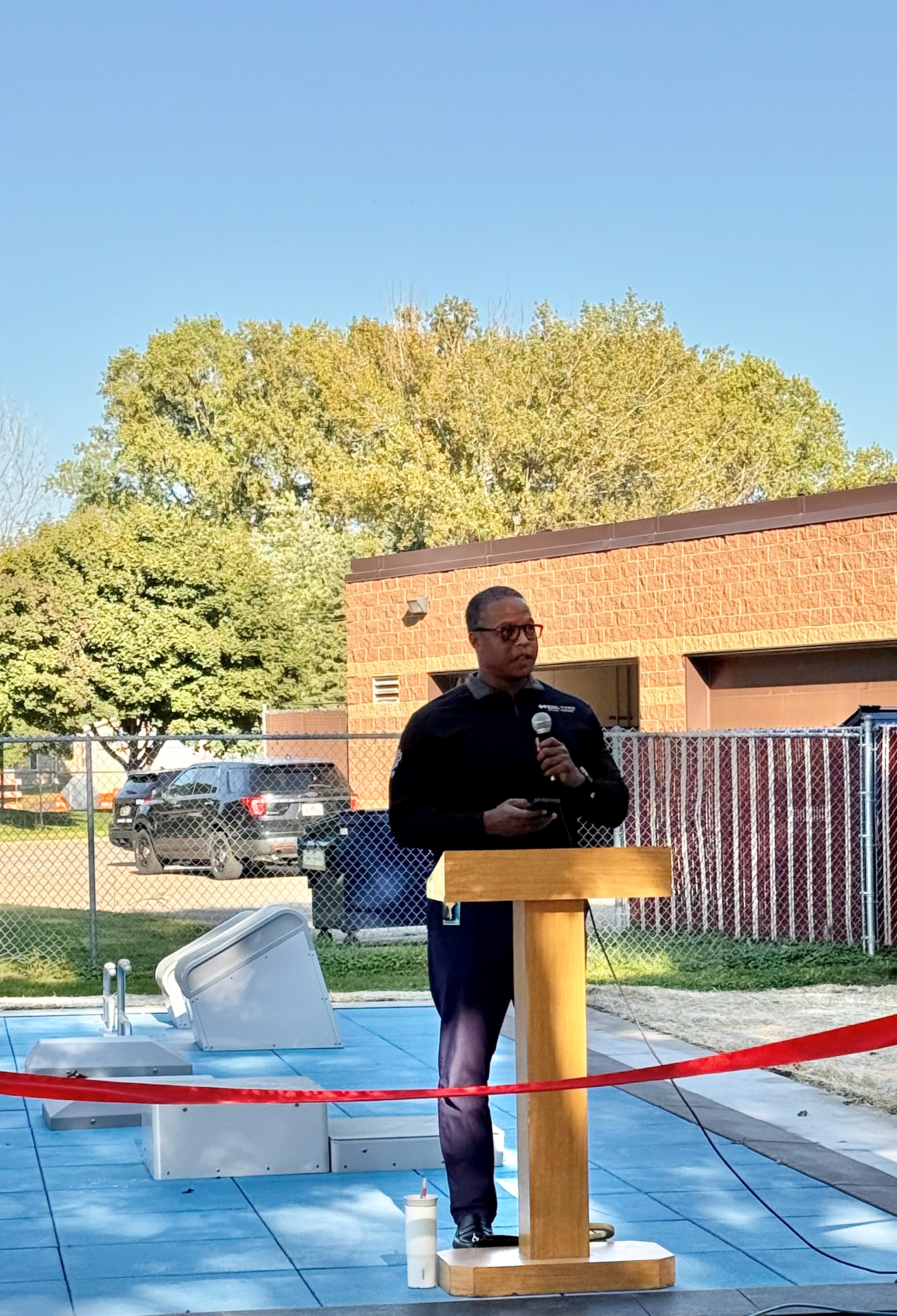 Bukata Hayes speaking at an outdoor podium