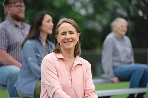 Female senior sitting in bleachers