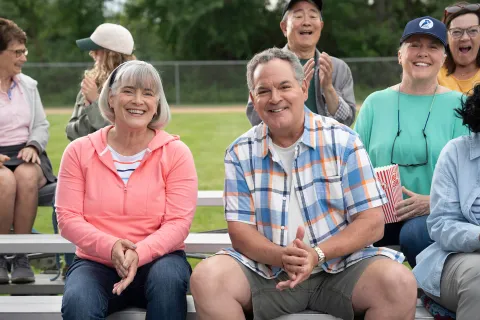 Senior couple sitting in the bleachers
