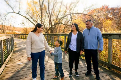 family walking on bridge in the fall