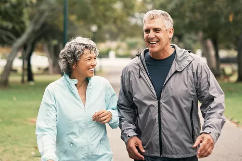 A couple walks in the park.