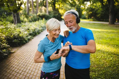 A couple looks at a smart watch.