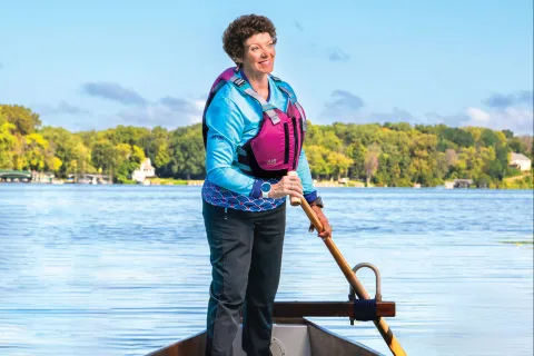 Cindi Fitch stands on her Dragon Boat.