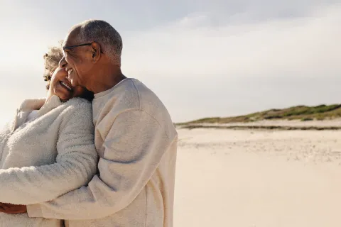 A couple hugs at the beach.