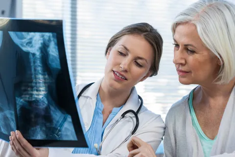 A woman looks over her X-ray.