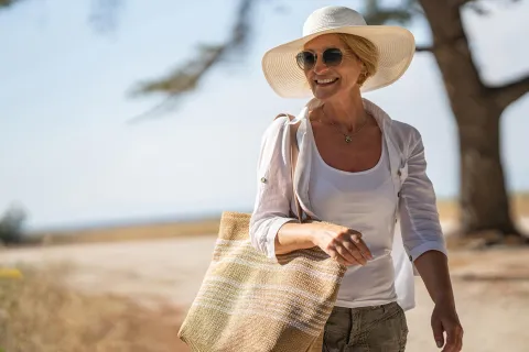 A woman heads to the beach.
