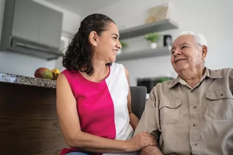 A woman smiles at a man.