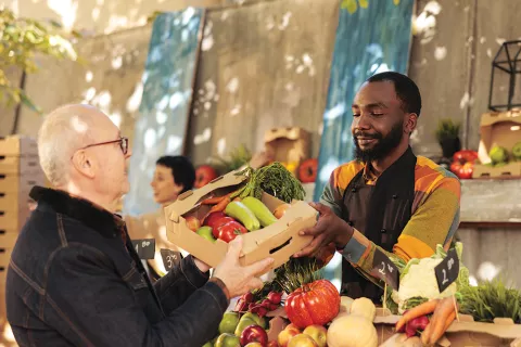 Man purchases vegetables.