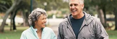 A couple walks in the park.