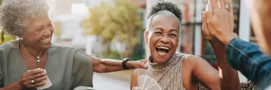 A woman gives a high five while playing cards.