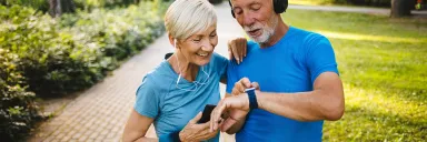 A couple looks at a smart watch.