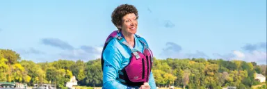 Cindi Fitch stands on her Dragon Boat.