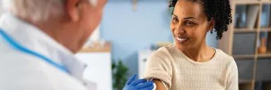 A Woman is about to receive a vaccine.