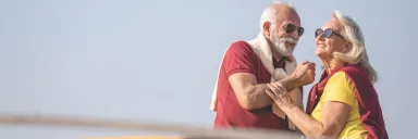 A couple enjoys the sun with sunglasses. 