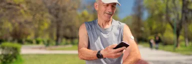 A man checks his blood sugar using a continuous blood glucose monitor.