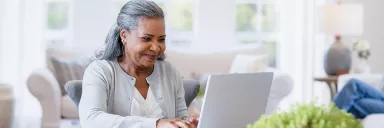 Woman at computer smiling.