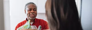 A man delivers a bag of groceries.