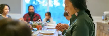 A woman prays before a meal.