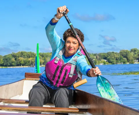 Cindi Fitch paddles on a dragon boat.