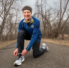Marathon Mike ties his running shoes.